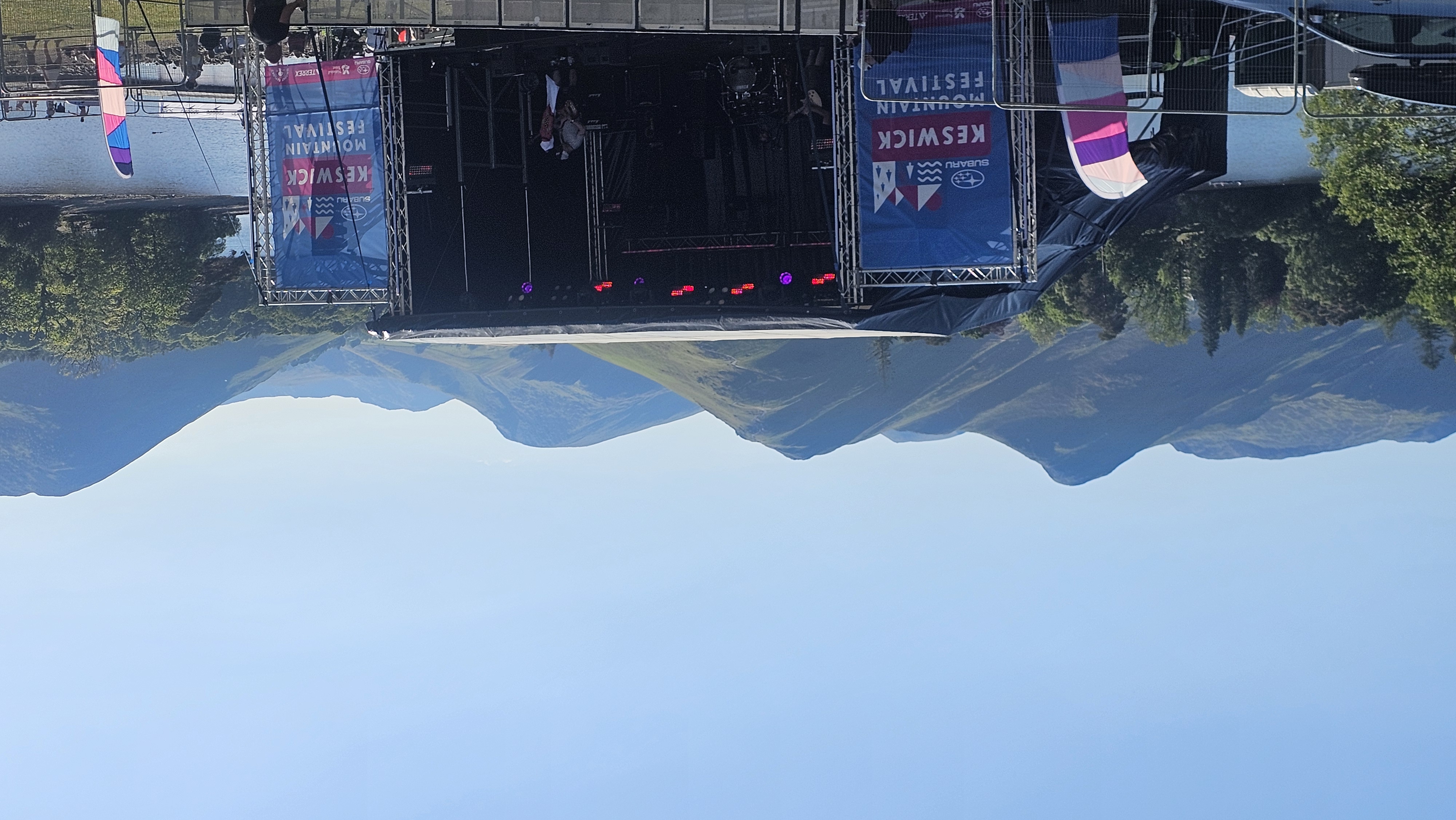 The Keswick Mountain Festival stage in the festival village at Crow Park, with the fells behind