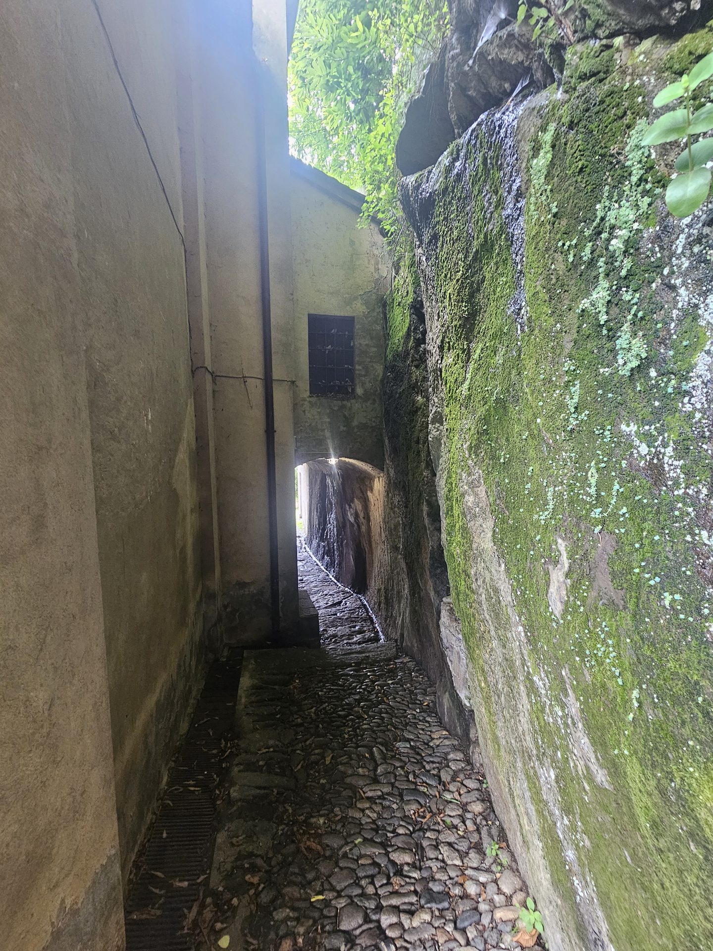 An old stone village fountain and water trough on the path above Gera Lario