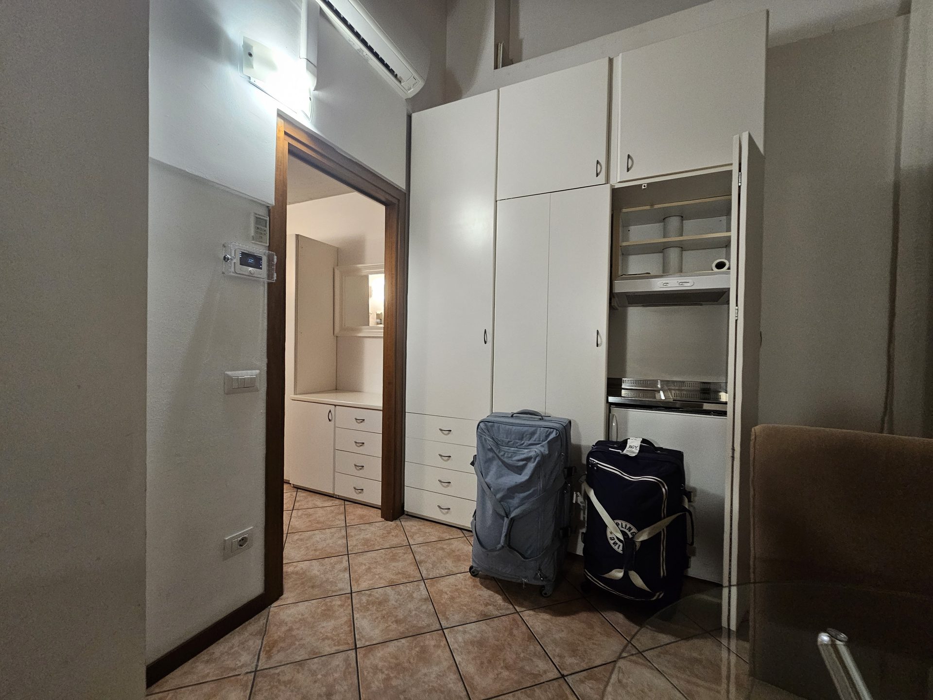 The fold-away kitchen at Residence Diaz, tucked behind cupboard doors in the apartment