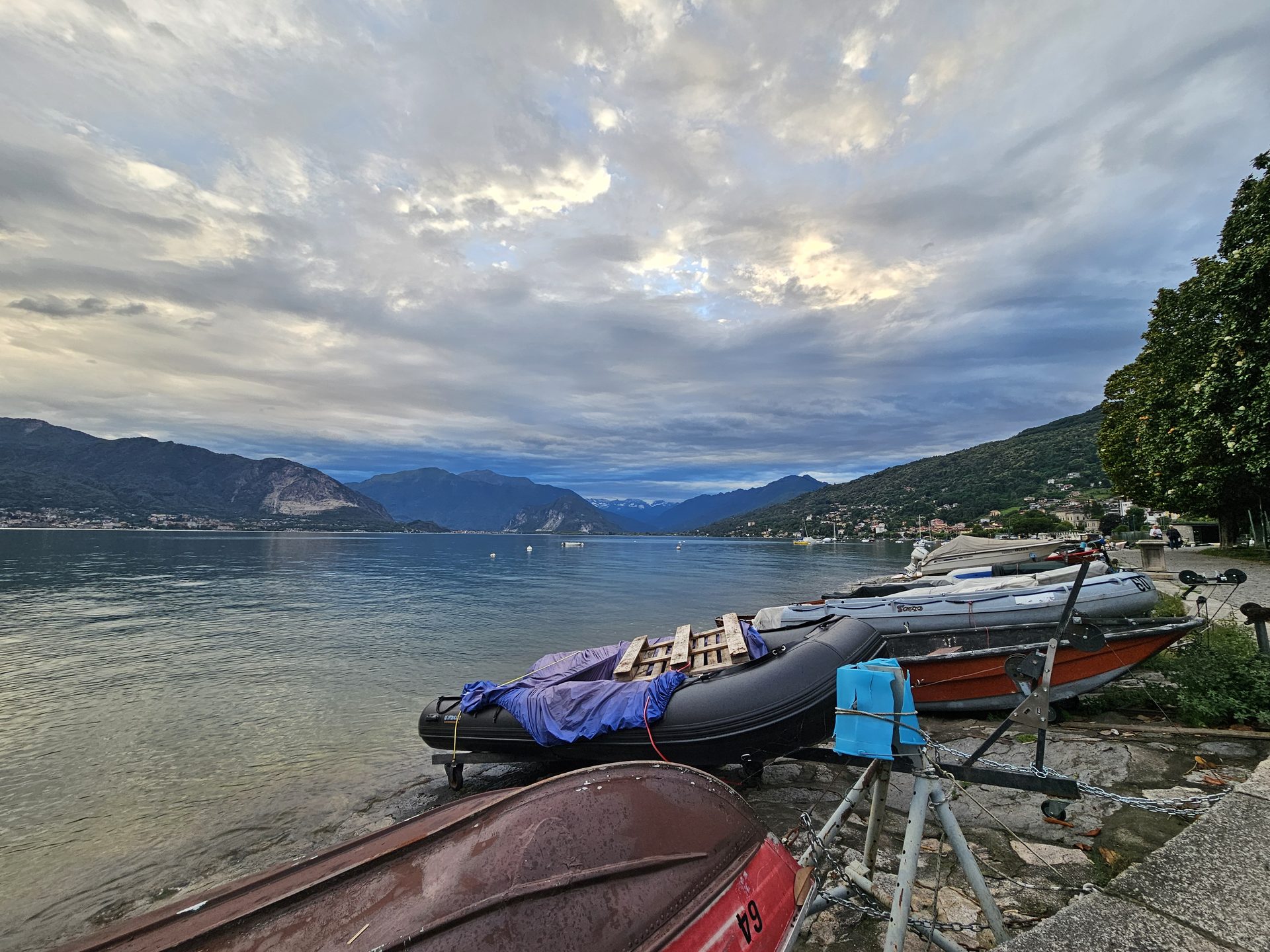Boats pulled up on the shore at Laveno under a moody Maggiore sky