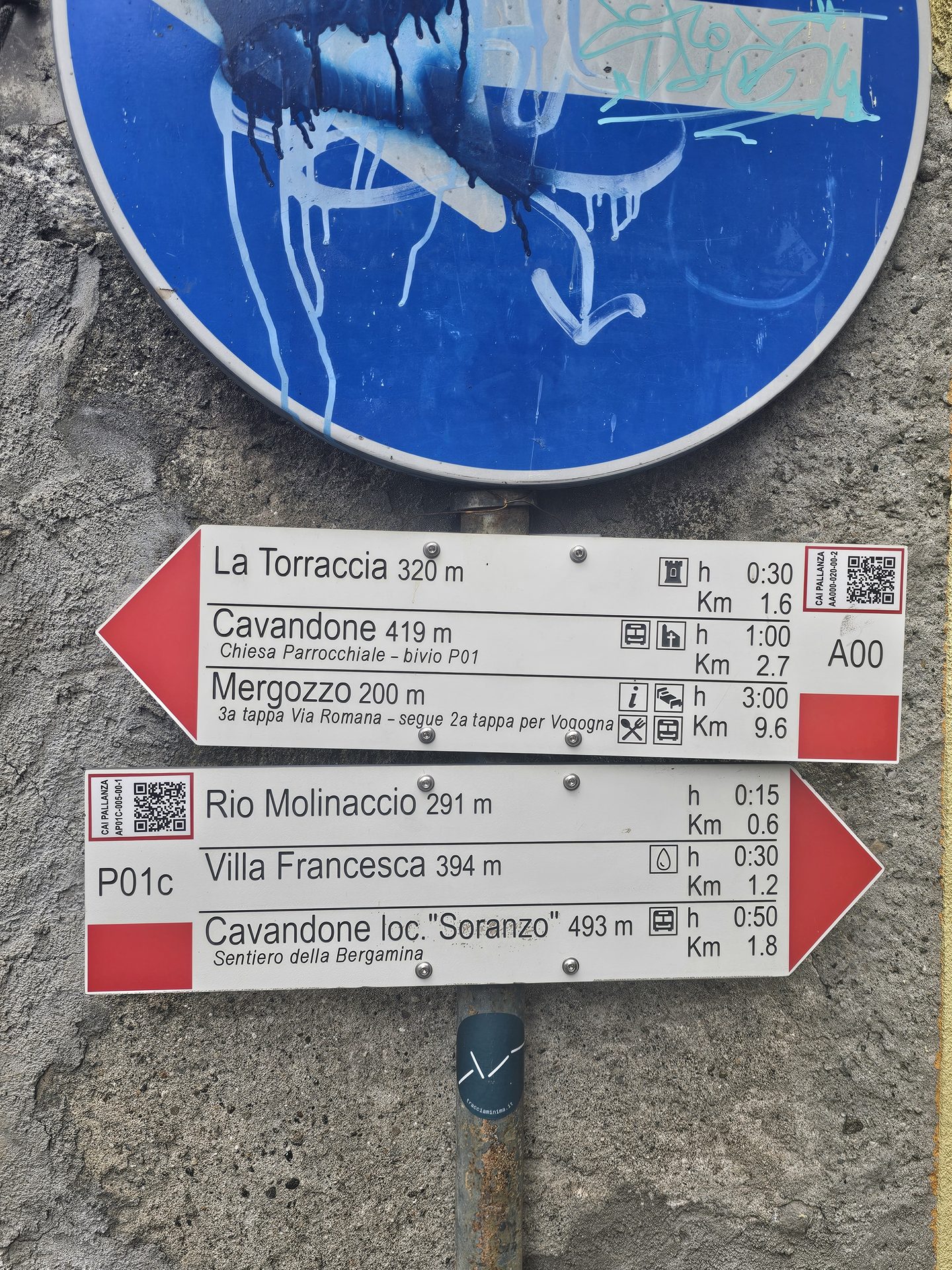 A red-and-white trail waymark sign in the hills above Verbania